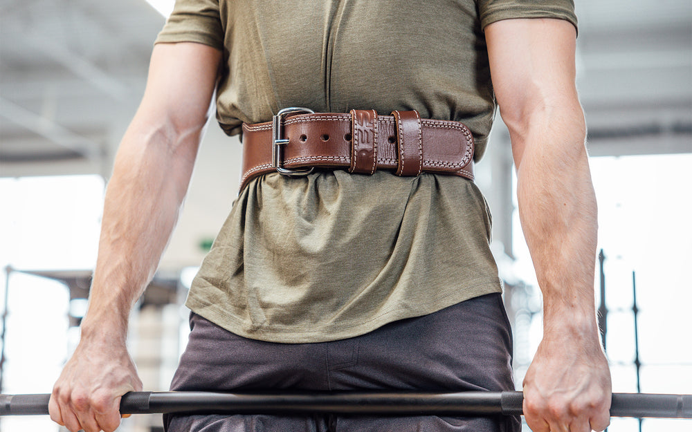 Front view of an athlete performing a deadlift while wearing a brown REP Leather Olympic Lifting Belt.