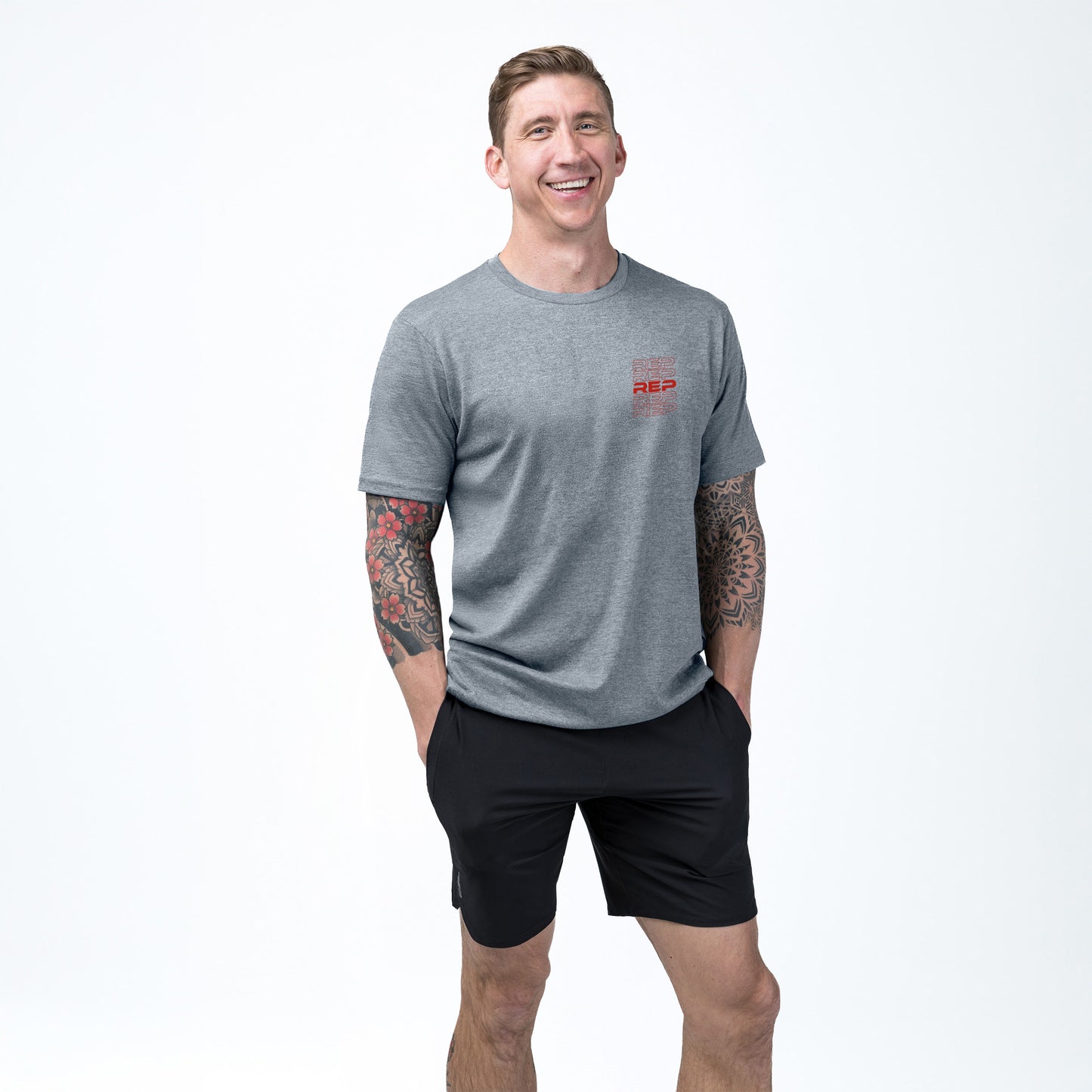 Athlete wearing the REP fitness Lift Club Tri-Blend Crew T-Shirt in Heather Flint/Red