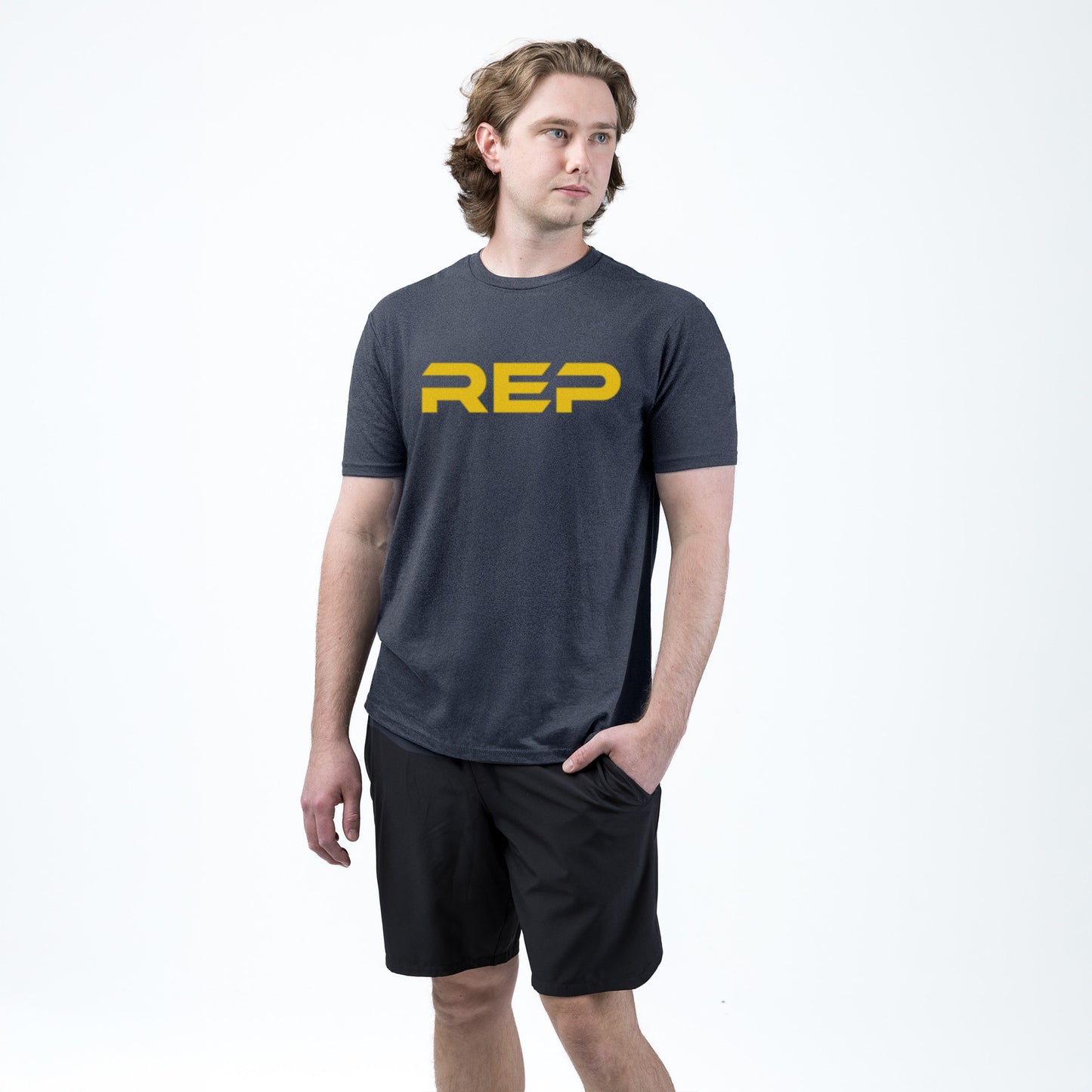 Athlete weaaring the REP fitness Men's Daily Driver 2.0 Tri-Blend Crew T-Shirt in Heather Navy/Yellow