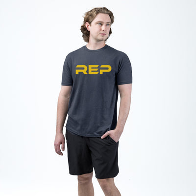 Athlete weaaring the REP fitness Men's Daily Driver 2.0 Tri-Blend Crew T-Shirt in Heather Navy/Yellow