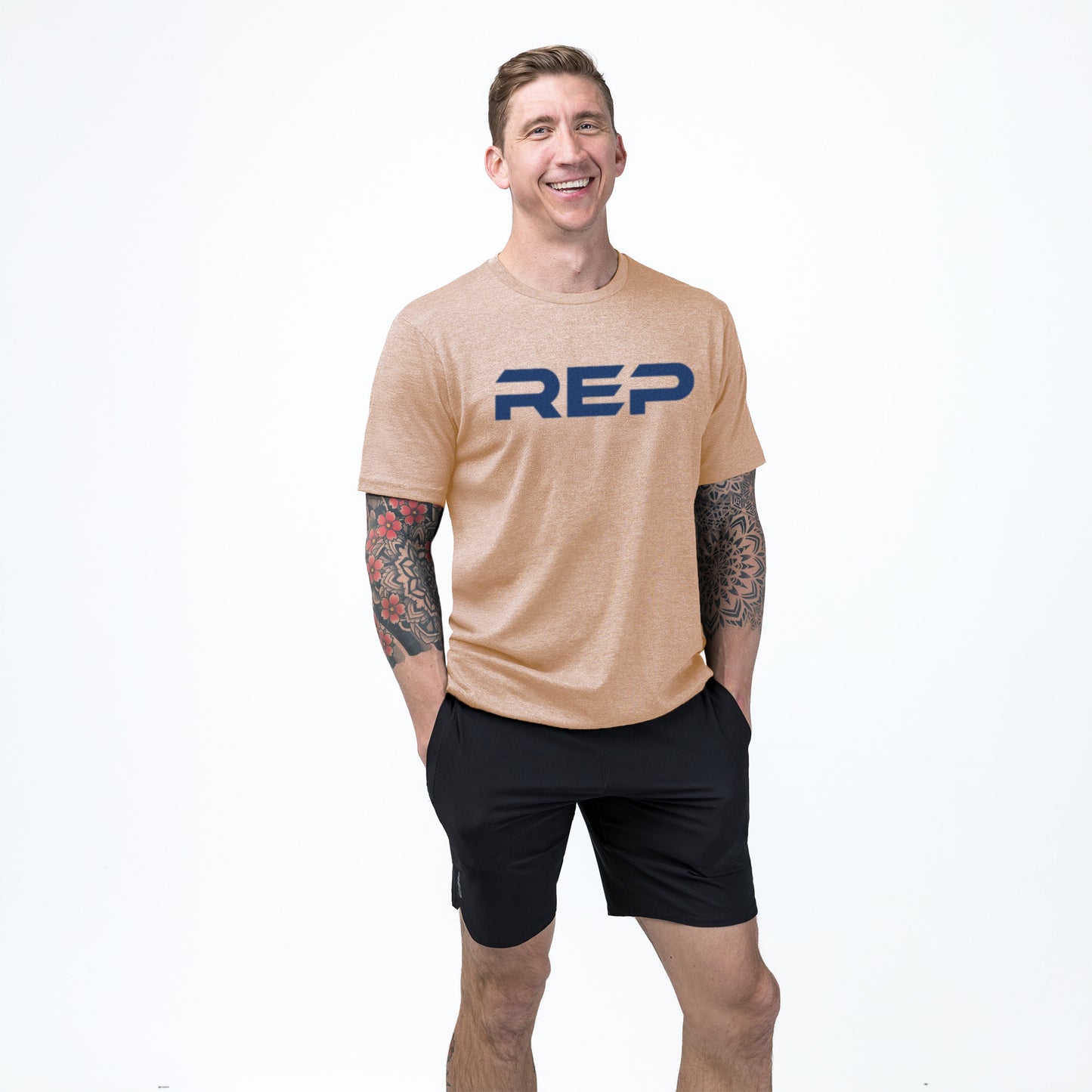 Athlete weaaring the REP fitness Men's Daily Driver 2.0 Tri-Blend Crew T-Shirt in Heather Peach/Blue
