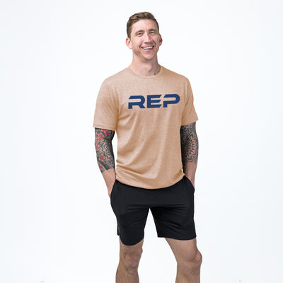 Athlete weaaring the REP fitness Men's Daily Driver 2.0 Tri-Blend Crew T-Shirt in Heather Peach/Blue