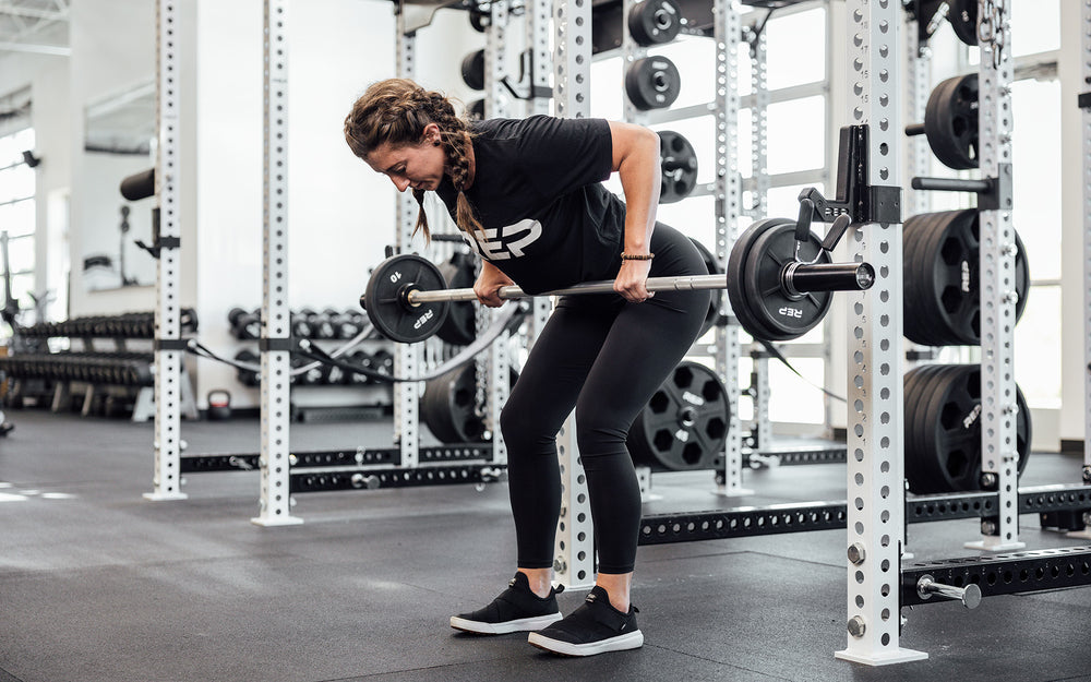 Female lifter performing a bent over row with a loaded REP Mesa Technique Bar.