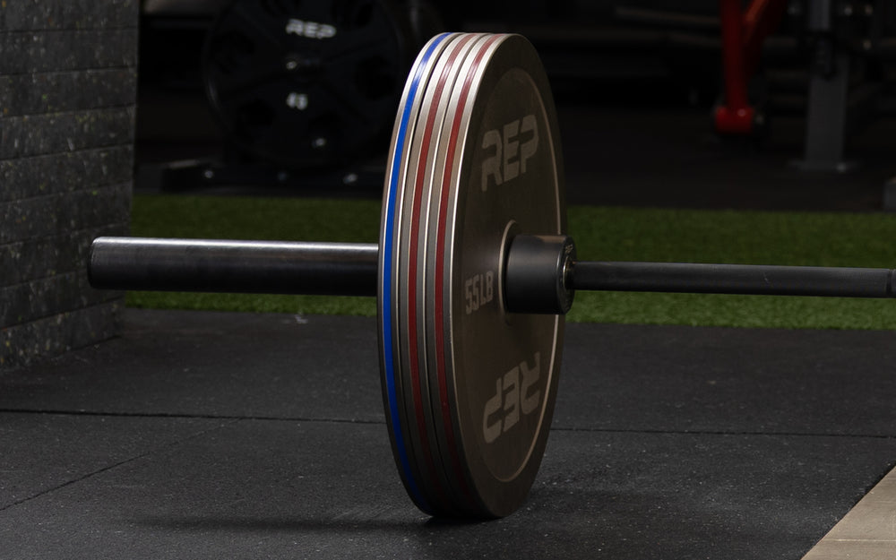 Rep Fitness Calibrated Steel Plates (LB) loaded onto a barbell
