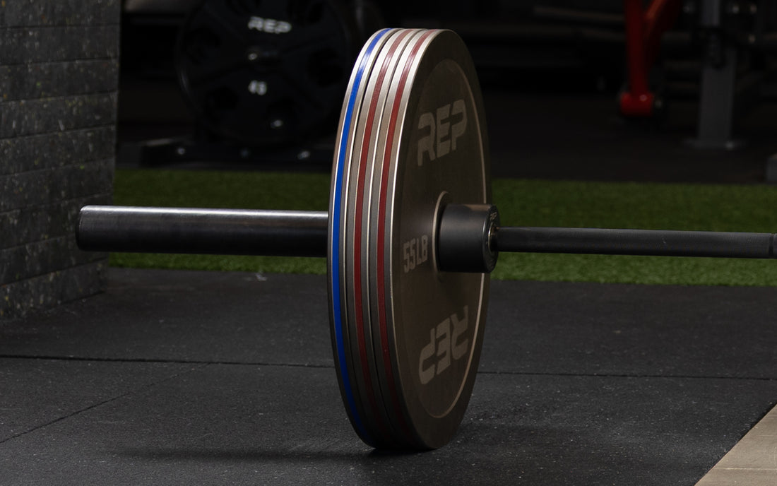Rep Fitness Calibrated Steel Plates (LB) loaded onto a barbell