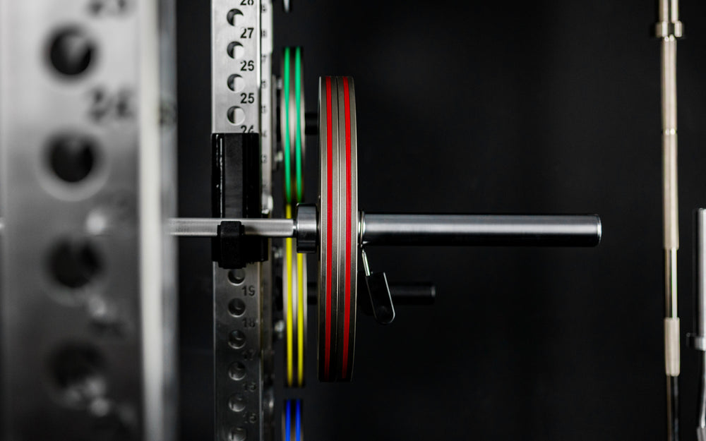 Front shot of Rep Fitness Calibrated Steel Plates (KG) loaded on a barbell, highlighting their thin width