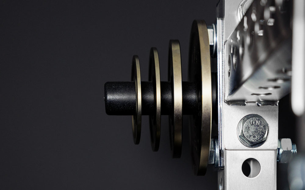 Rep Fitness Calibrated Steel Plates (LB) loaded on a weight horn, highlighting a calibrated tolerance