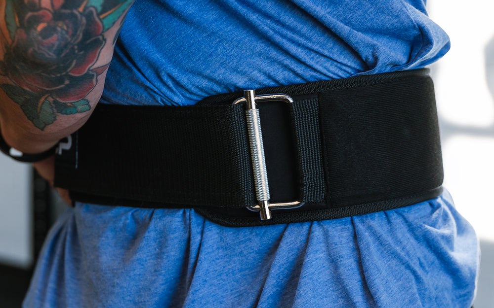 Athlete tightening the REP Nylon Lifting Belt.