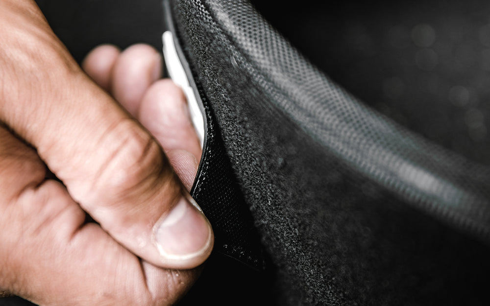 Close-up view of a patch being attached to the REP Nylon Lifting Belt.