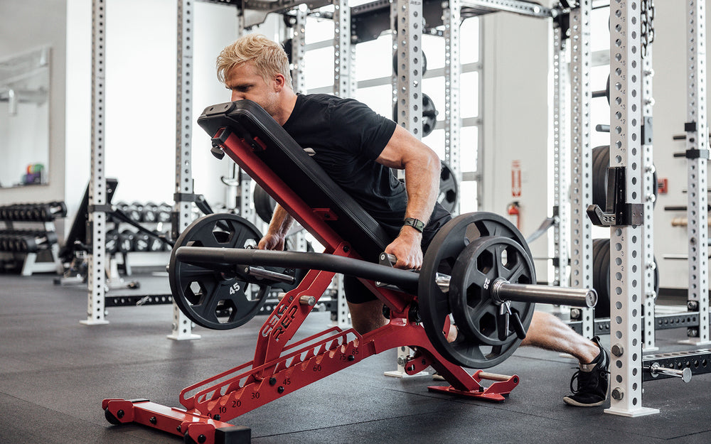 Male athlete performing an incline row on a REP bench with the REP Open Trap Bar.