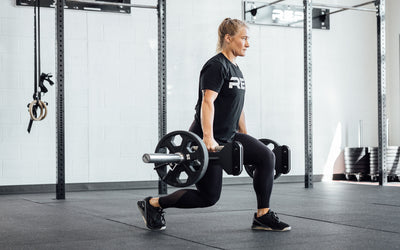Female athlete performing a lunge with the REP Open Trap Bar.