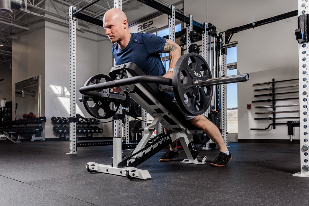 Man performing chest support row with the Fixed Open trap bar in a gym setting