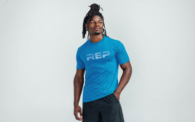 Athlete wearing REP fitness blueprint Tri-Blend Crew t-shirt in Heather Royal/White