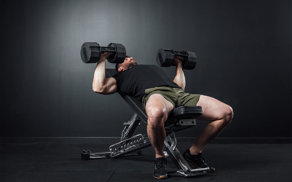 Athlete performing an incline bench press with a pair of REP x PÉPIN FAST Series Adjustable Dumbbells.