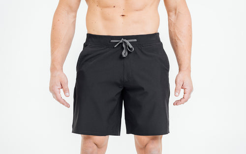 Front view of model wearing the black REP Pinnacle Shorts.