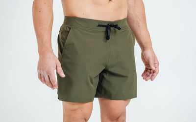 Front view of model wearing the Olive REP Pinnacle Shorts.