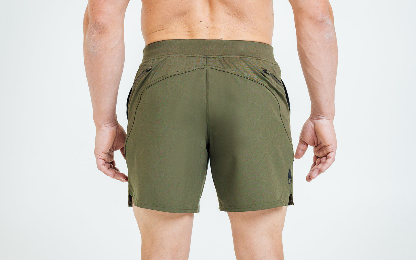 Back view of model wearing the Olive REP Pinnacle Shorts.