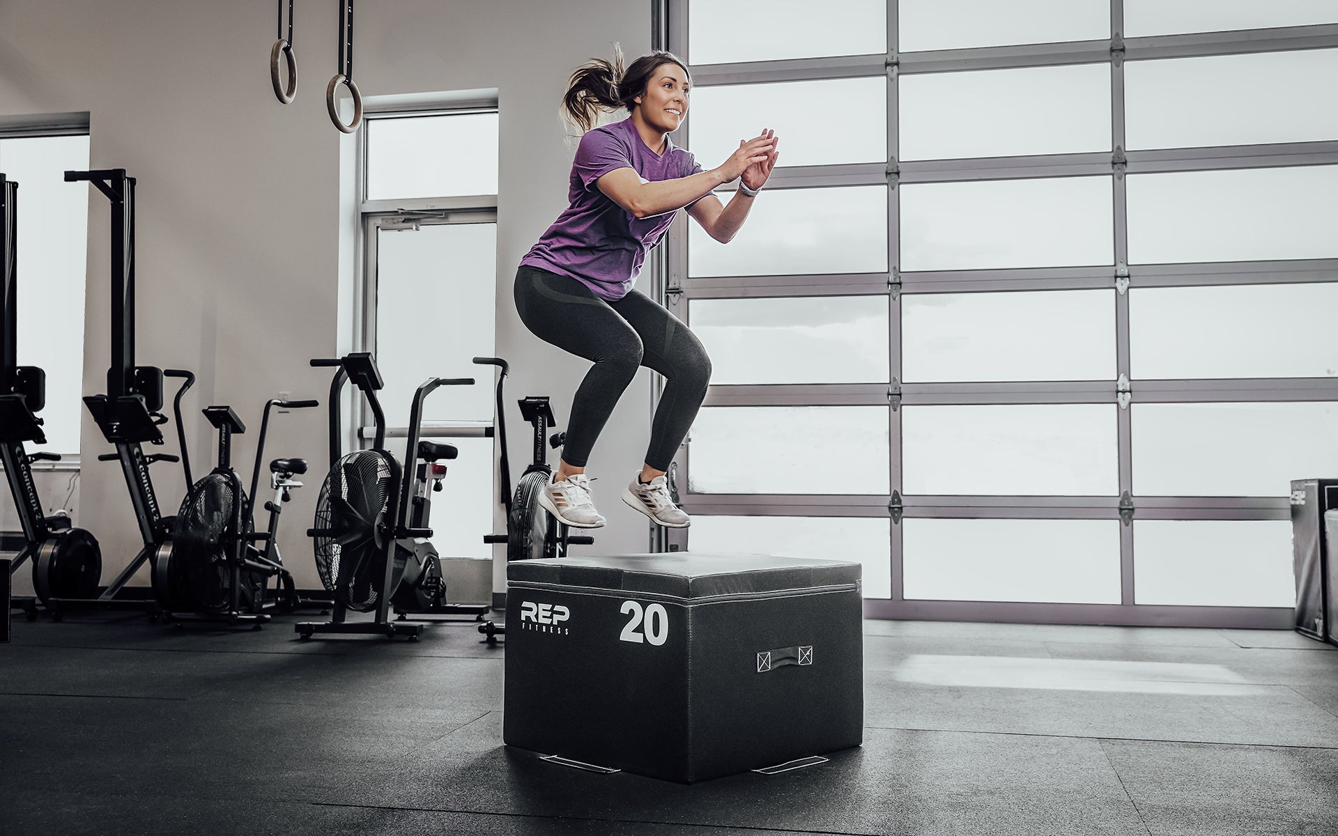 Female athlete performing box jumps on a 20