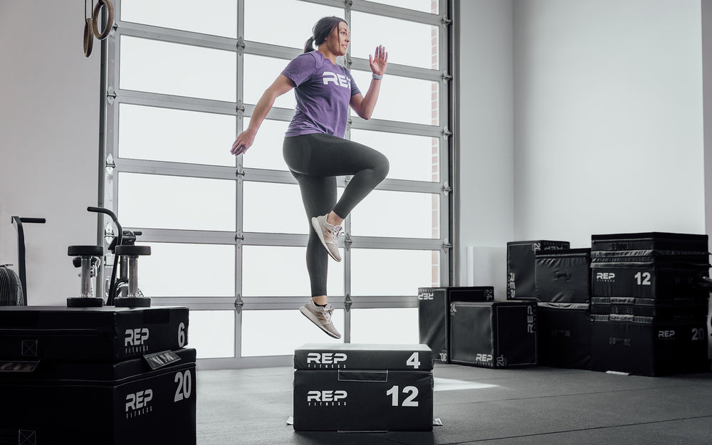 Female athlete performing 16" box jumps on 4" and 12" stacked REP Stackable Soft Plyo Boxes.