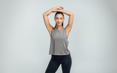 Woman wearing Heather Gray/Mauve Peak Cropped Dual-Blend Tank - Arms up