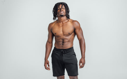 Front view of model wearing the heather black REP Attis Shorts.
