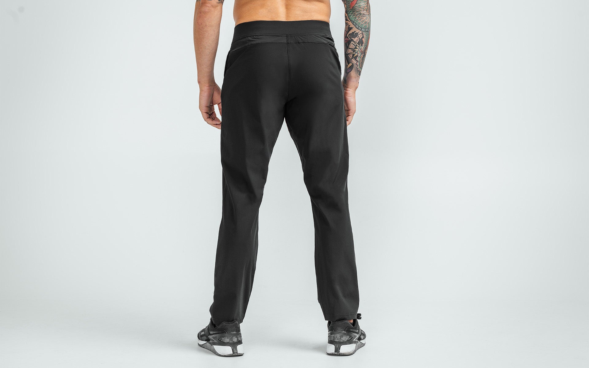 Back view of model wearing the black REP Felix Pants.
