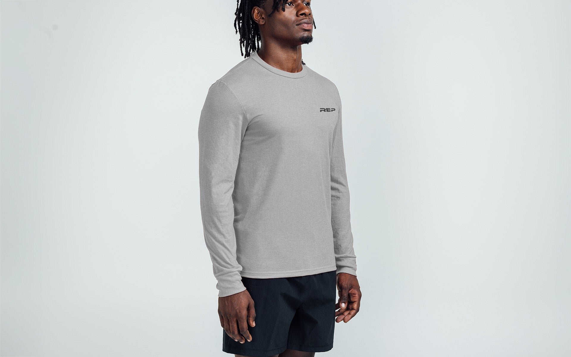 Man wearing Heather Gray/Black Long-Sleeved Tri-Blend Crew