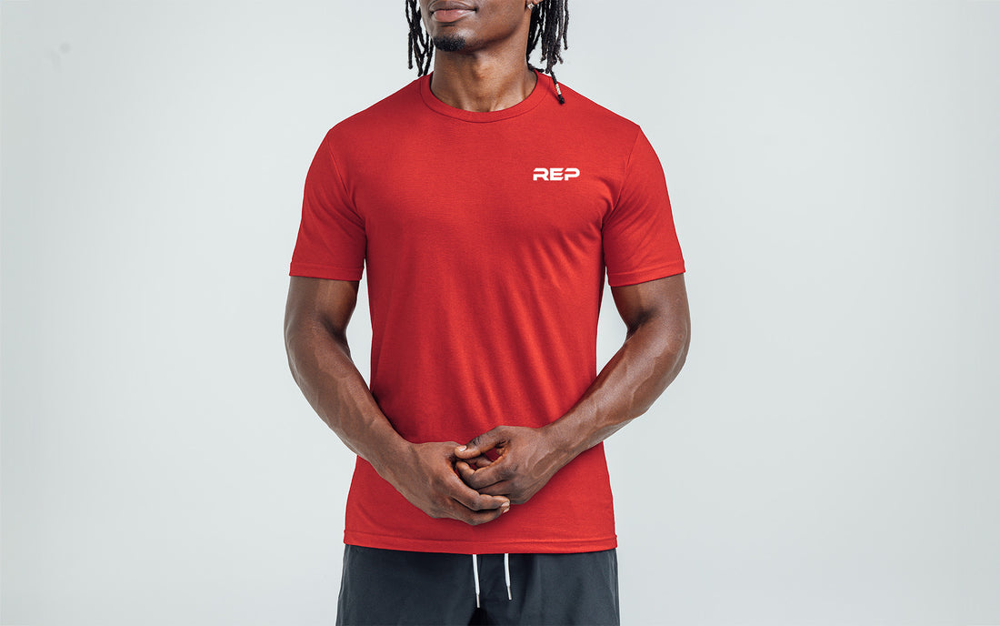 The REP Fitness Men's USA Tri-Blend Crew T-Shirt in Heather Red/White front, on model
