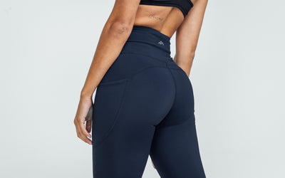 Back view of model wearing the REP Hera Tights in Navy.