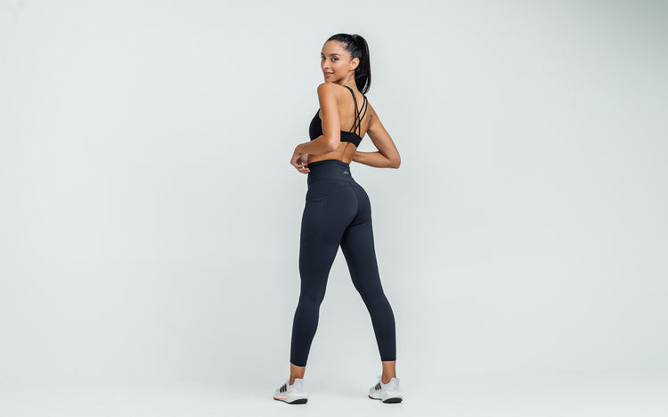 Back view of model wearing the REP Hera Tights in Navy.