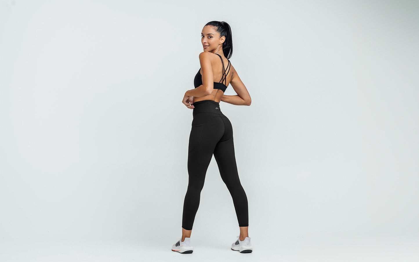 Back view of model wearing the REP Hera Tights in Black.