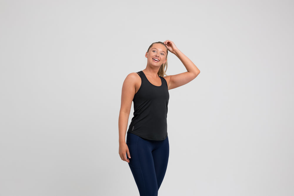 Athlete wearing a black REP Women’s Clio Tank Top.