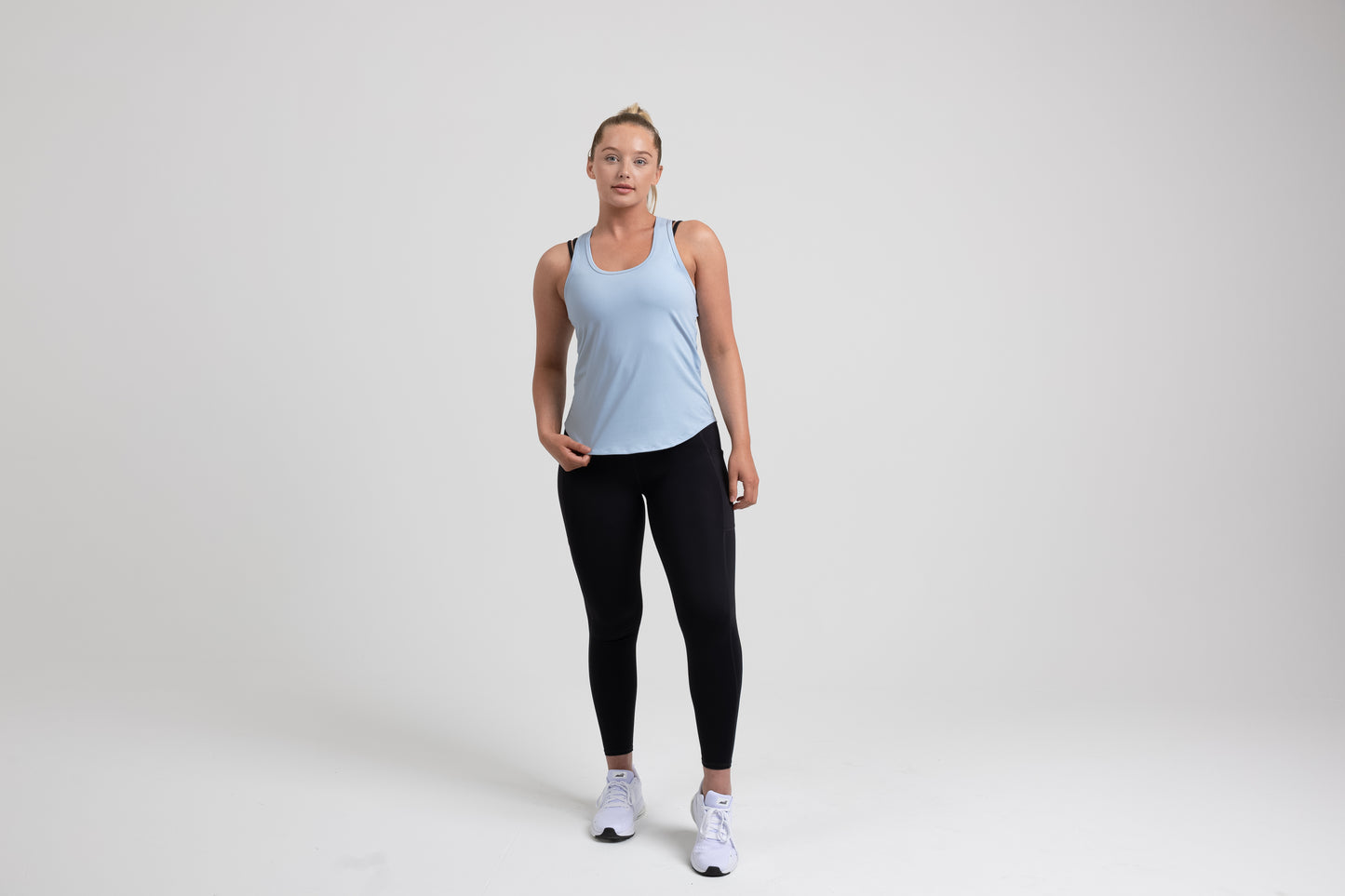 Athlete wearing a periwinkle REP Women’s Clio Tank Top.