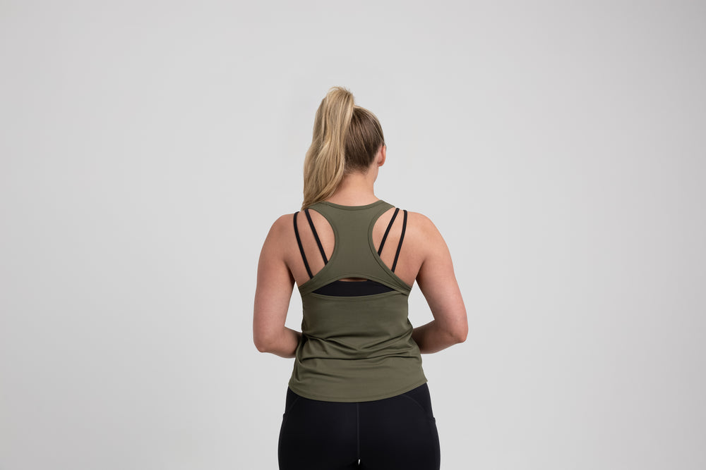 Athlete wearing an olive REP Women’s Clio Tank Top.