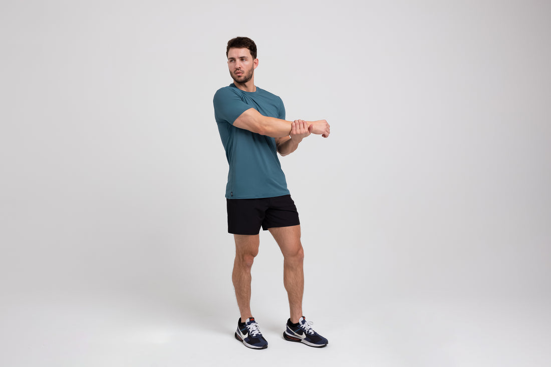 The REP Fitness Men's Delta Shirt in Slate front, stretching