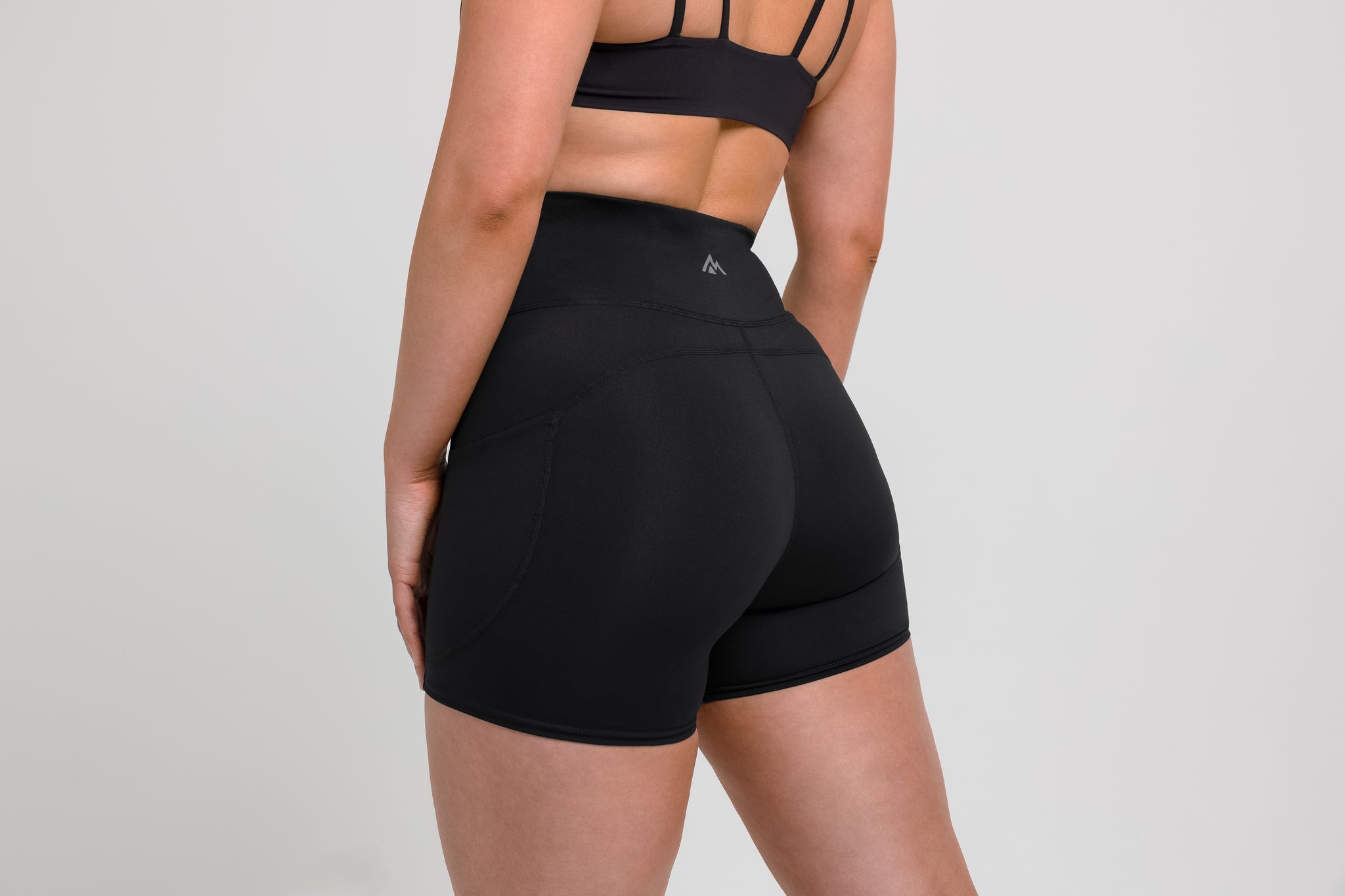 Women's Shorts - Athlete wearing the Black REP Women’s Forma Shorts on a gray background.
