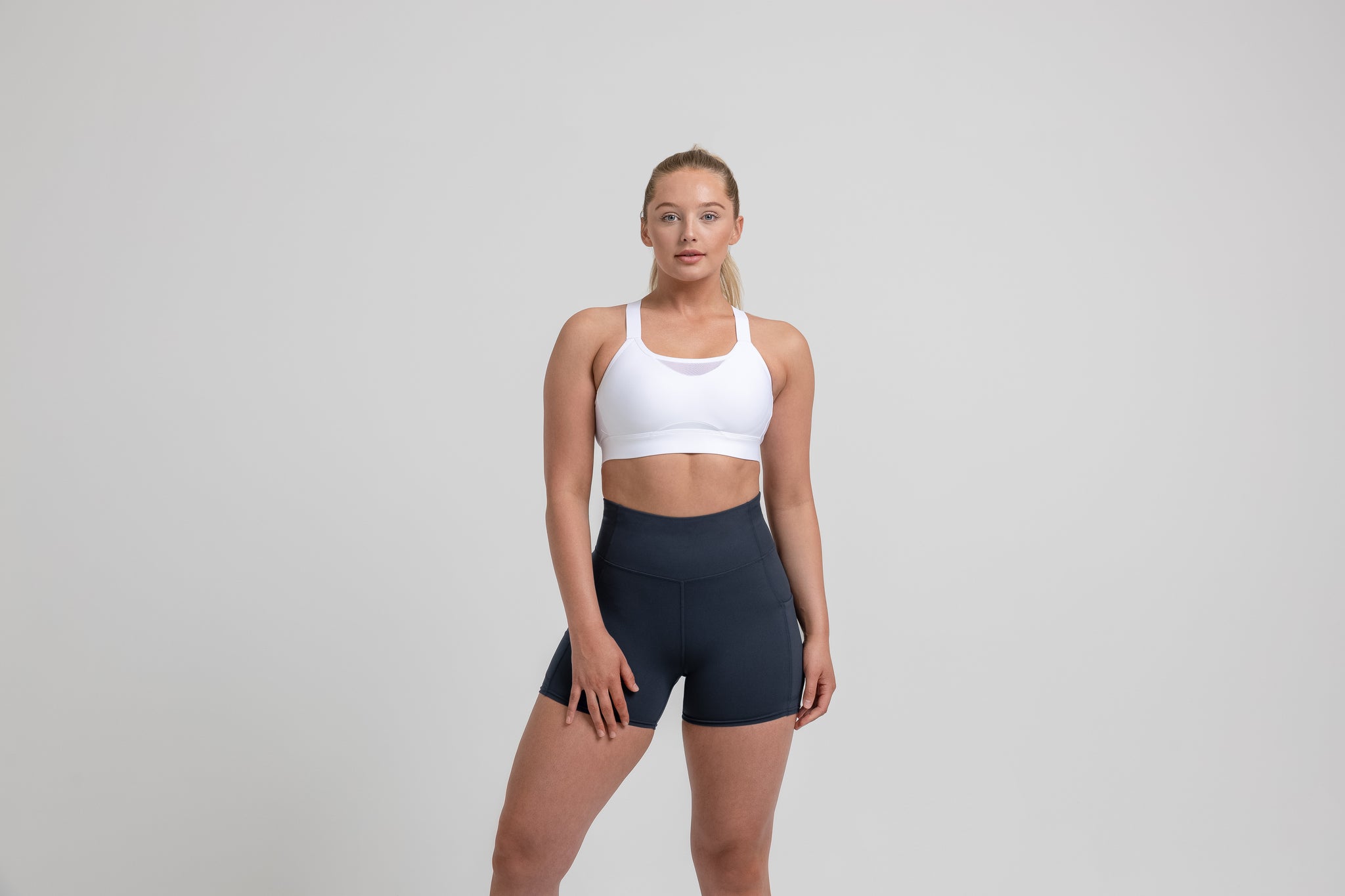 Athlete wearing the Navy REP Women’s Forma Shorts.