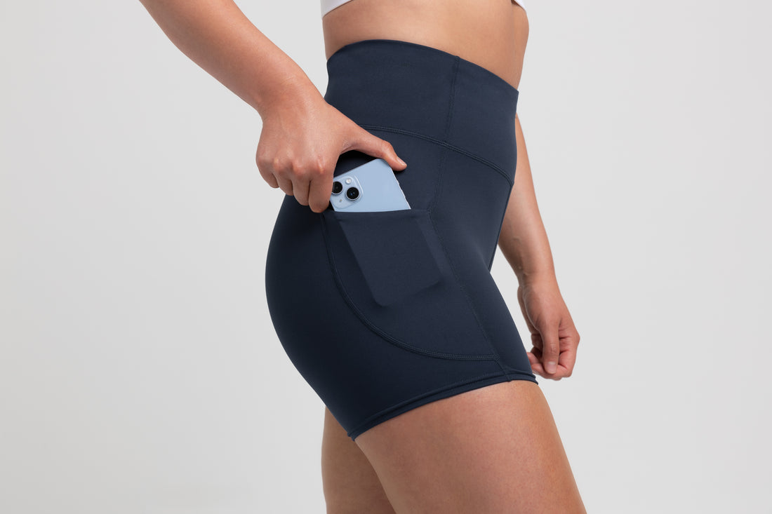 The REP Fitness Women's Forma Shorts in Navy on body, pocket detail
