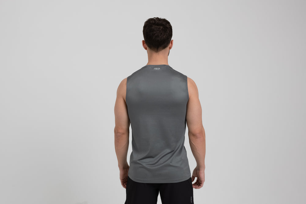 Athlete wearing a cool gray REP Men's Solis Muscle Tee.