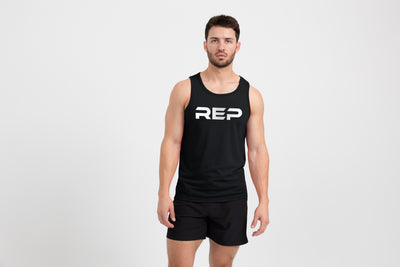 Man wearing the Men's Daily Driver Tri-Blend Tank in Heather Black with shorts