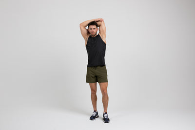 The REP Fitness Men's Solis Muscle Tee in Black front, arms overhead stretch