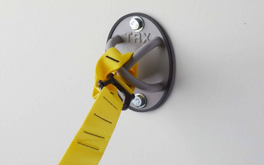 Close-up: A TRX Suspension Trainer™ attached to a TRX X-Mount® mounted on a wall