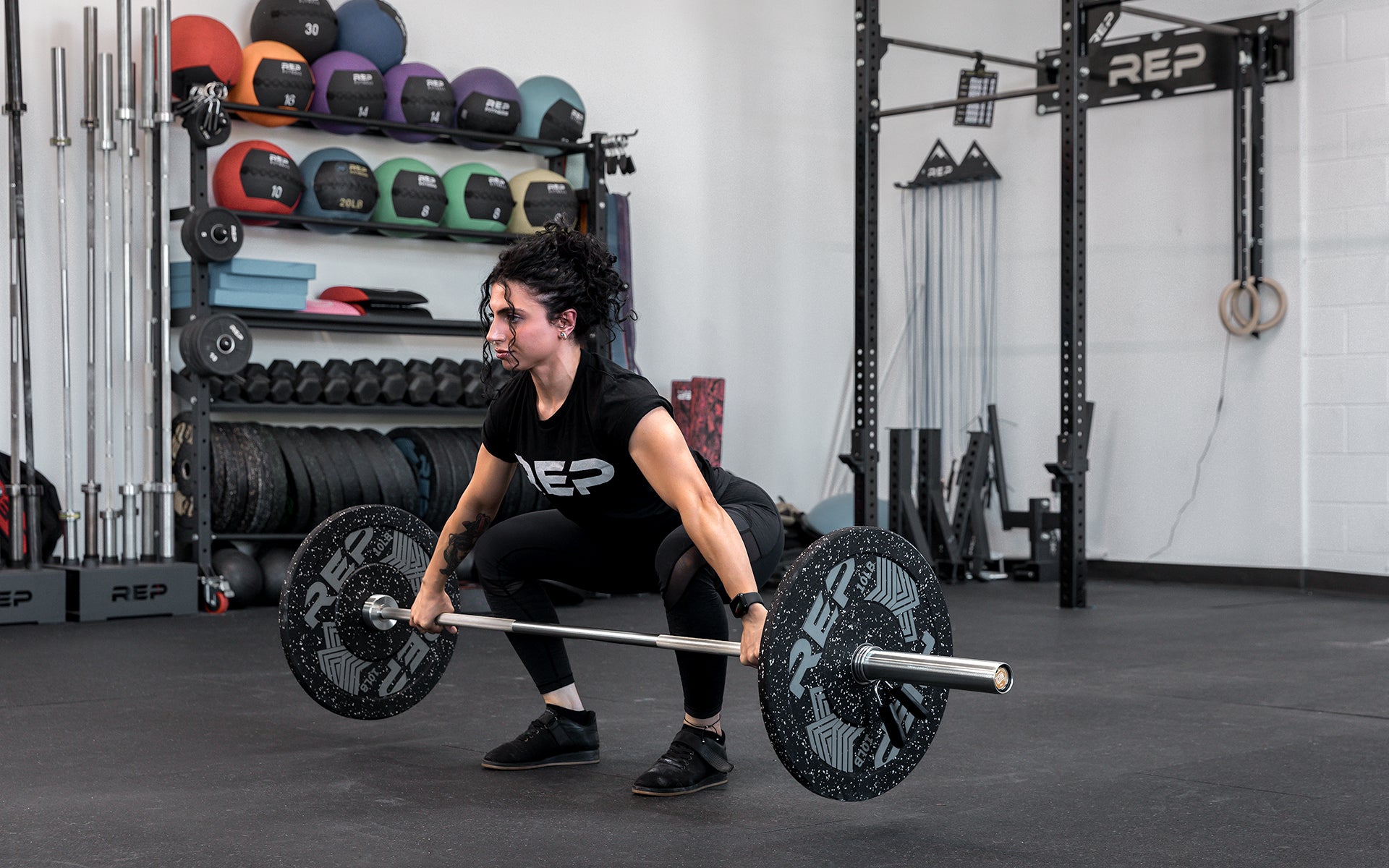 Athlete performing a snatch with the REP 15kg Teton Training Bar.