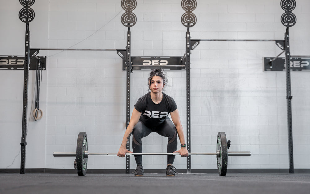 Athlete getting ready to perform a clean using the REP 15kg Teton Training Bar.