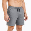 Front view of model wearing the heather cool gray REP Versa Shorts.