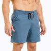 Front view of model wearing the heather slate blue REP Versa Shorts.