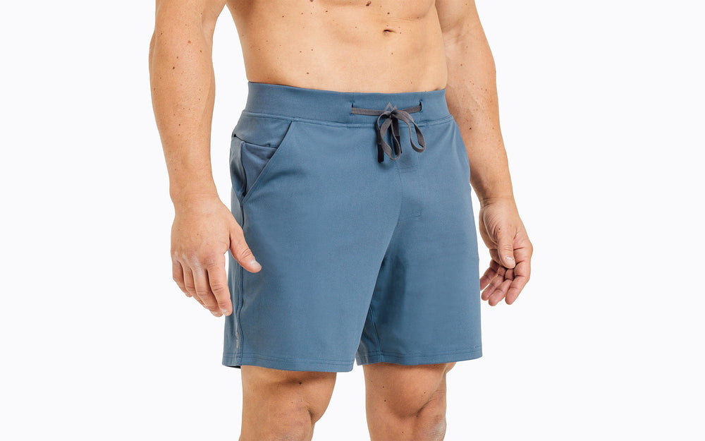 Front view of an athlete wearing the REP Versa Shorts in heather slate blue