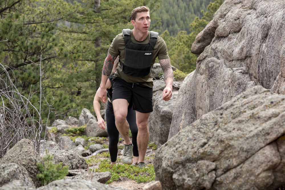 Athlete hiking in the with the Black Strata Weight Vest