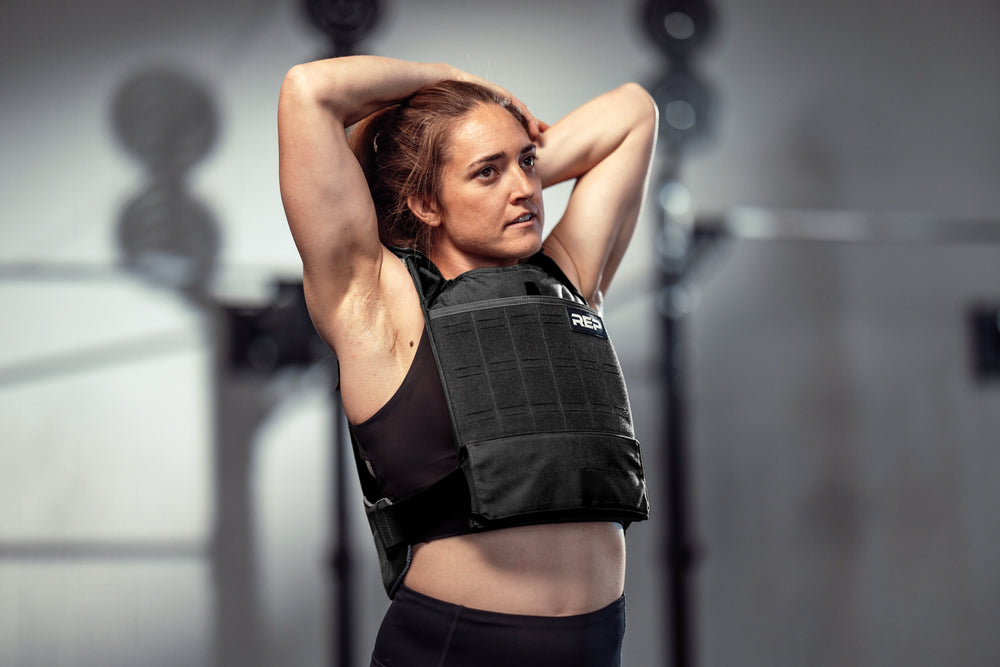 Athlete performing upper body stretches in the black Strata Weight Vest