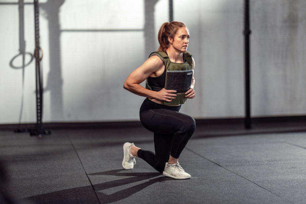 Athlete wearing the olive Strata Weight Vest doing lunges